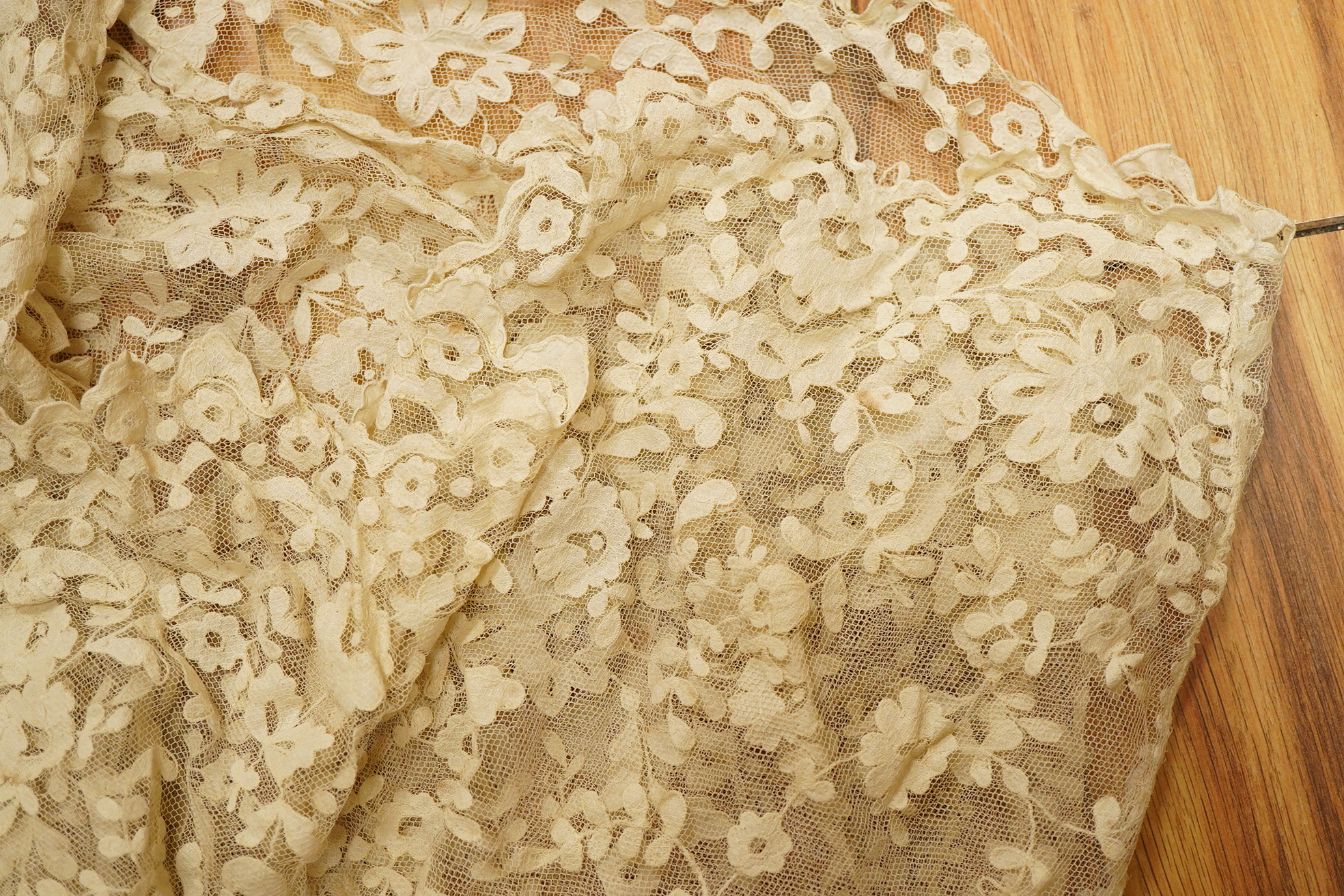 An Irish late 19th, Carrick Cross, Irish lace ladies shaped cape with collar, 200cm wide x 88cm long. Condition - a few dark rust stains and slight catches to net, but mainly in good condition.